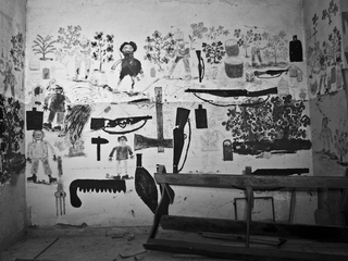 Illustration for article titled Photos of an abandoned asylum shot in black and white, complete with creepy mural